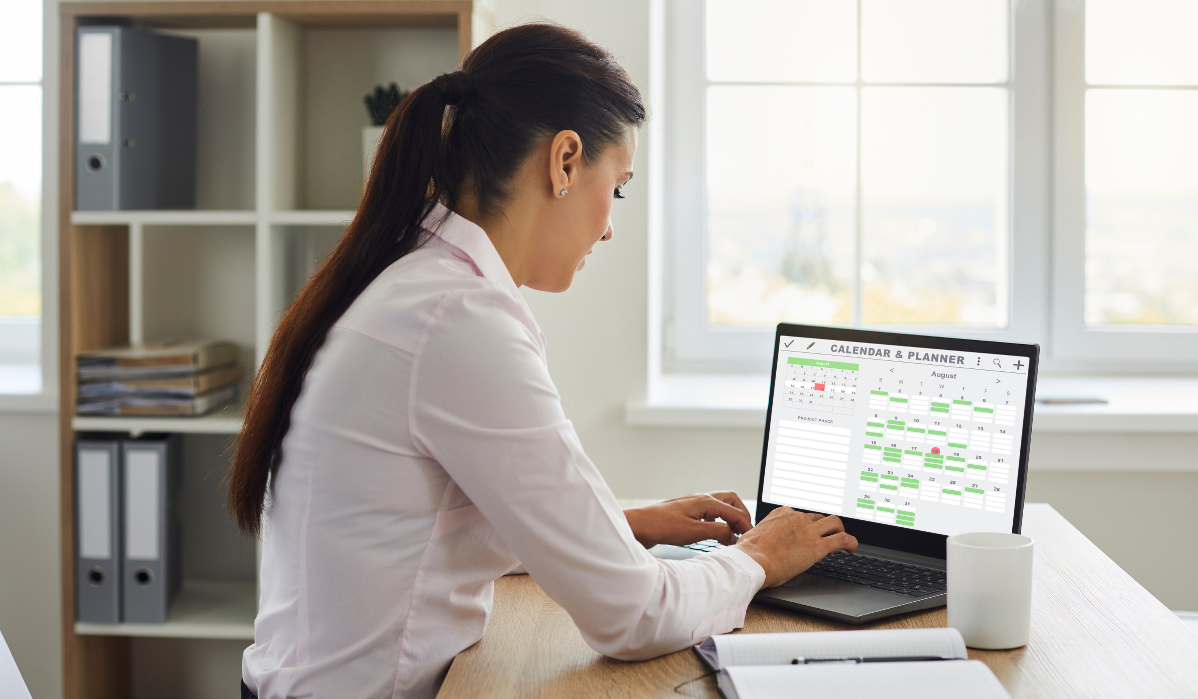 Remote professional reviewing a digital calendar and planner at a home-office desk